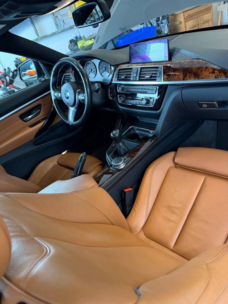 Leather car seats and dashboard cleaned during a mobile interior detail in Massachusetts