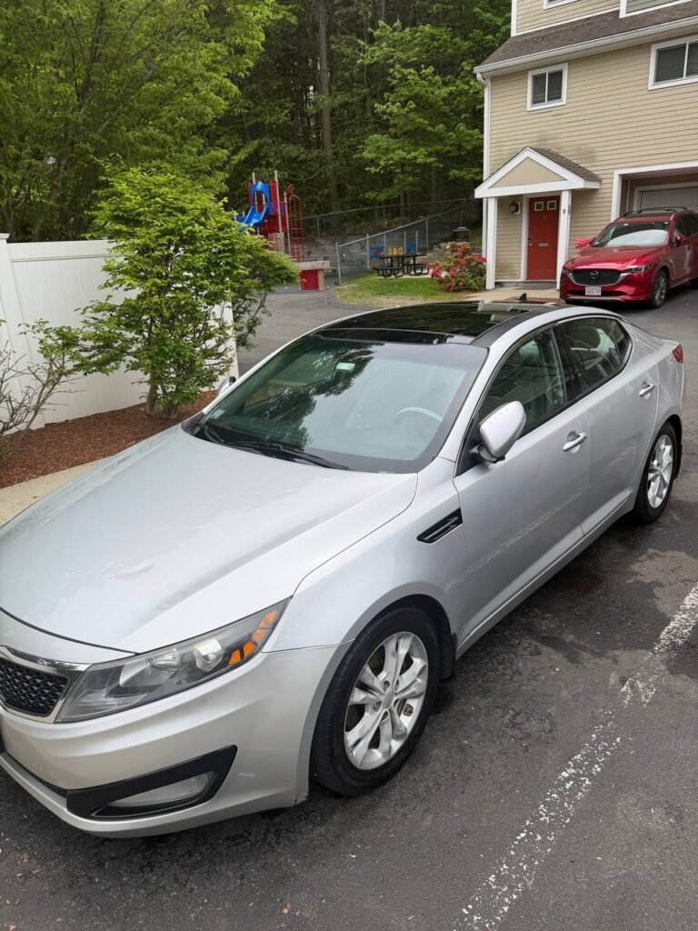 A sedan detailed same-day in a residential driveway in Massachusetts