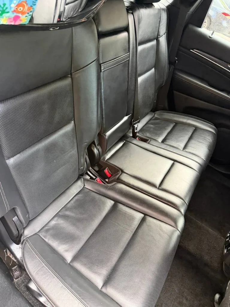 Spotless rear floor mats in black SUV after professional mobile detailing service Massachusetts
